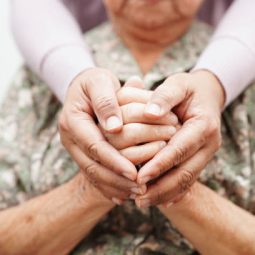 Caregiver holding hands Asian elderly woman patient, help and care in hospital.